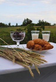a plate of croissants and a glass of milk on a table