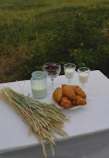 Rustic breakfast setup on a wooden table outdoors with fresh fruits and coffee.