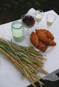 Photo of fresh dairy and non-dairy ingredients neatly arranged on a wooden table.