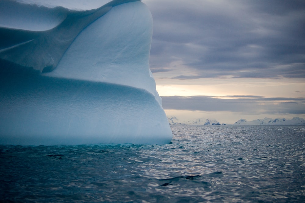 a large iceberg floating on top of a body of water