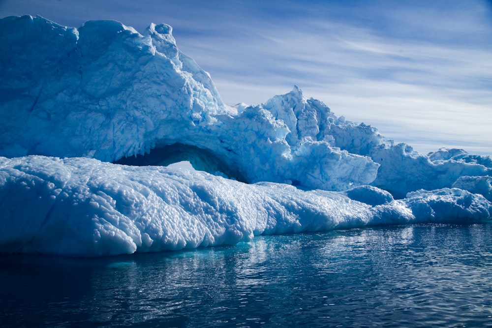 a group of icebergs floating on top of a body of water