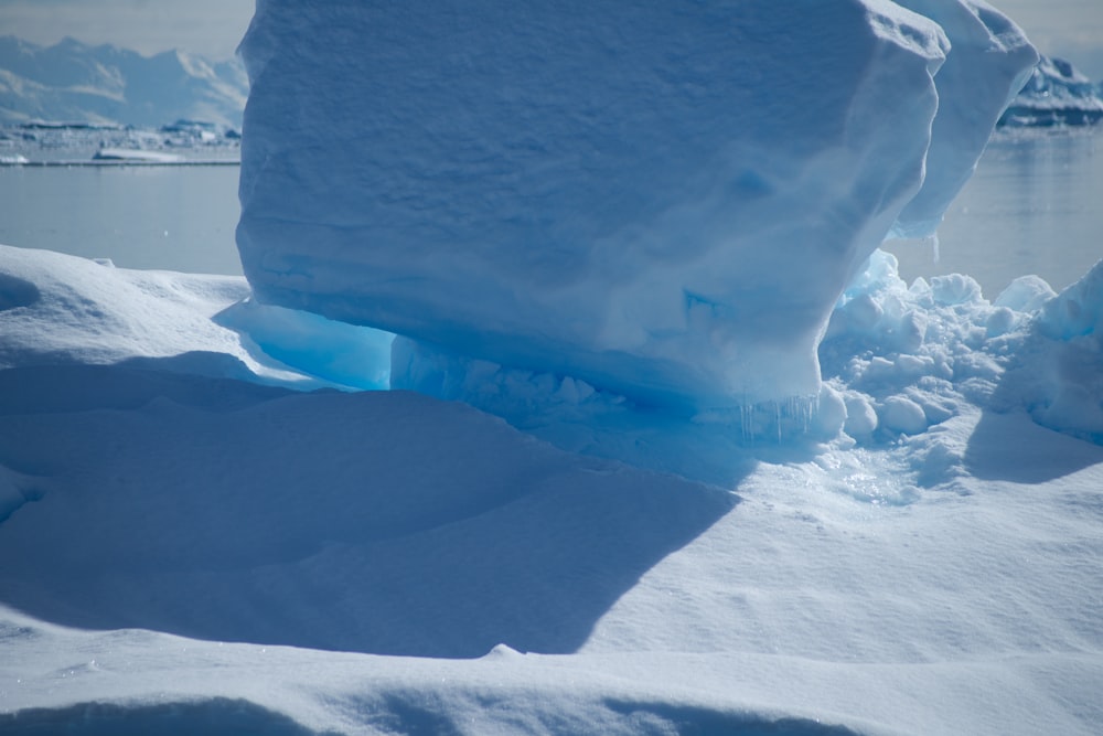 a large iceberg in the middle of a body of water