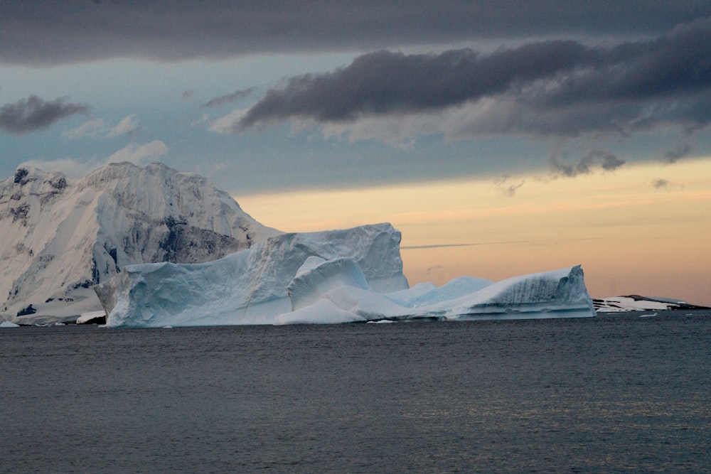 a large iceberg floating on top of a body of water