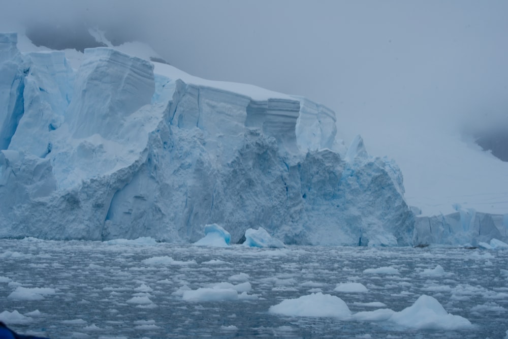 a large iceberg in the middle of a body of water