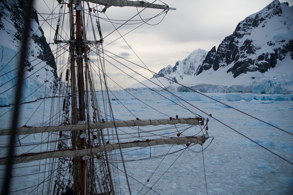 a ship in a body of water with mountains in the background