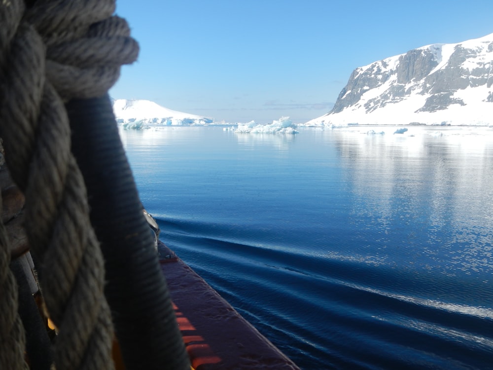 a view of a body of water with icebergs in the background