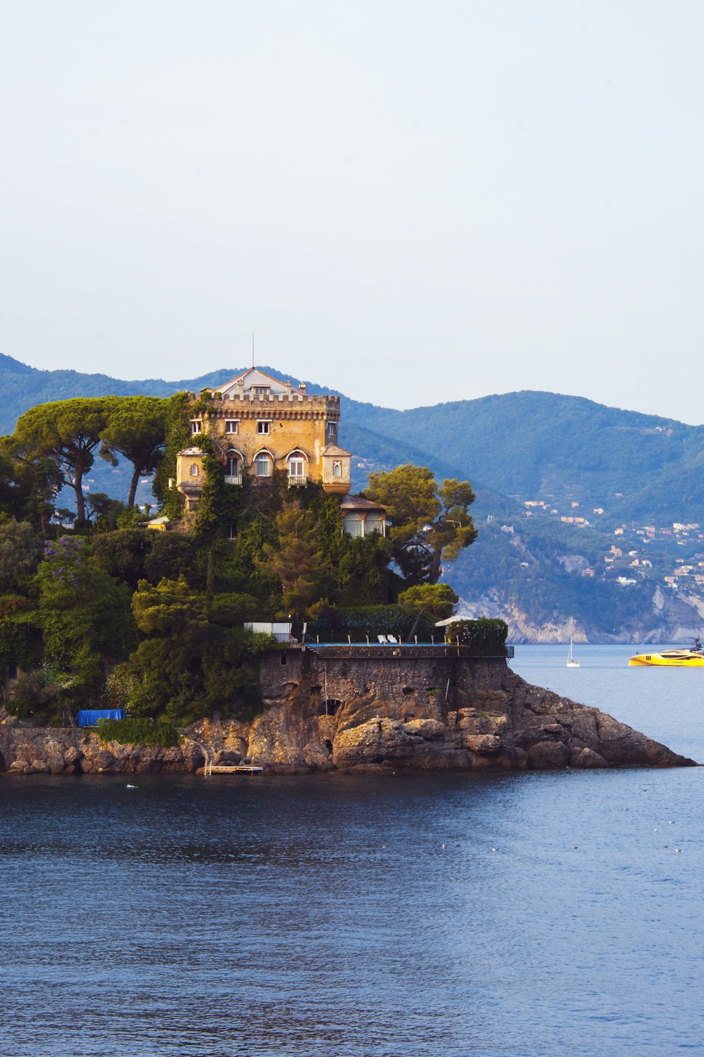 a house on a small island in the middle of the ocean