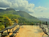 An inviting outdoor terrace with comfortable seating and lush greenery.