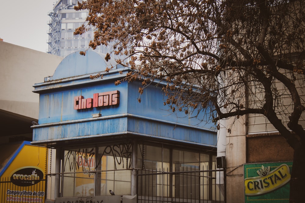 a blue building with a sign on the front of it