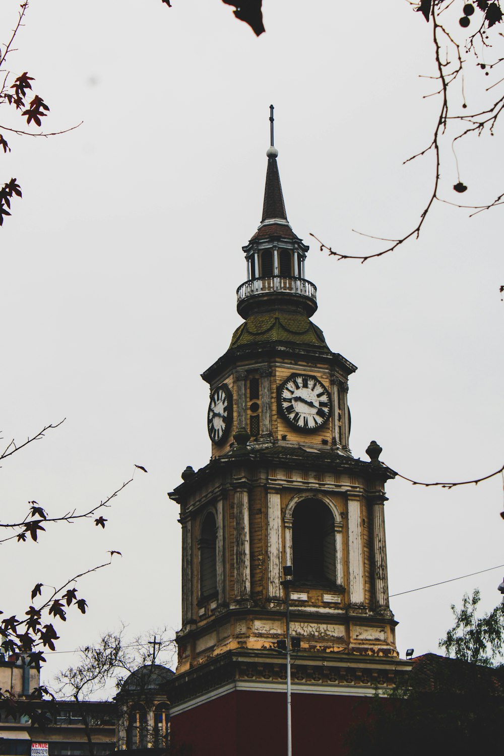 a tall clock tower with a clock on each of it's sides