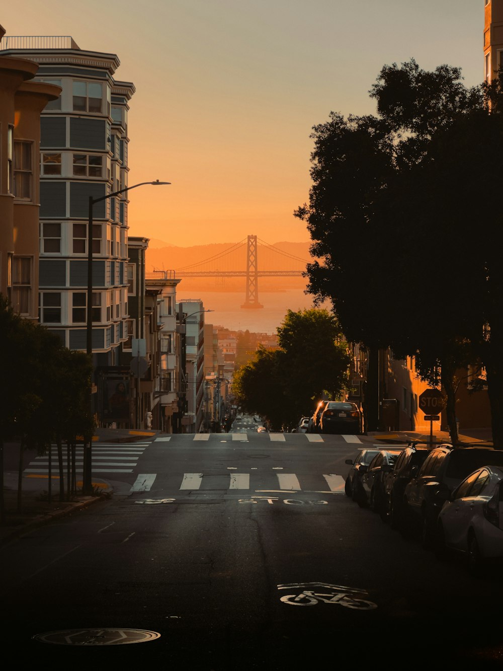 a city street with a bridge in the background