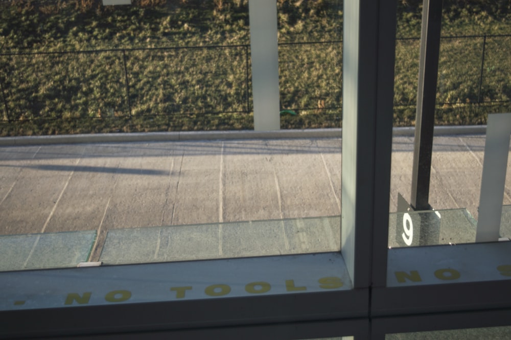 a view of a street through a glass door