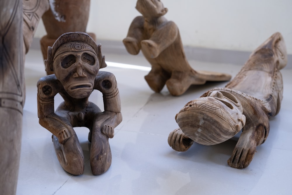 a group of carved wooden animals sitting next to each other
