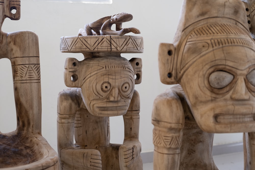 a group of wooden sculptures sitting next to each other