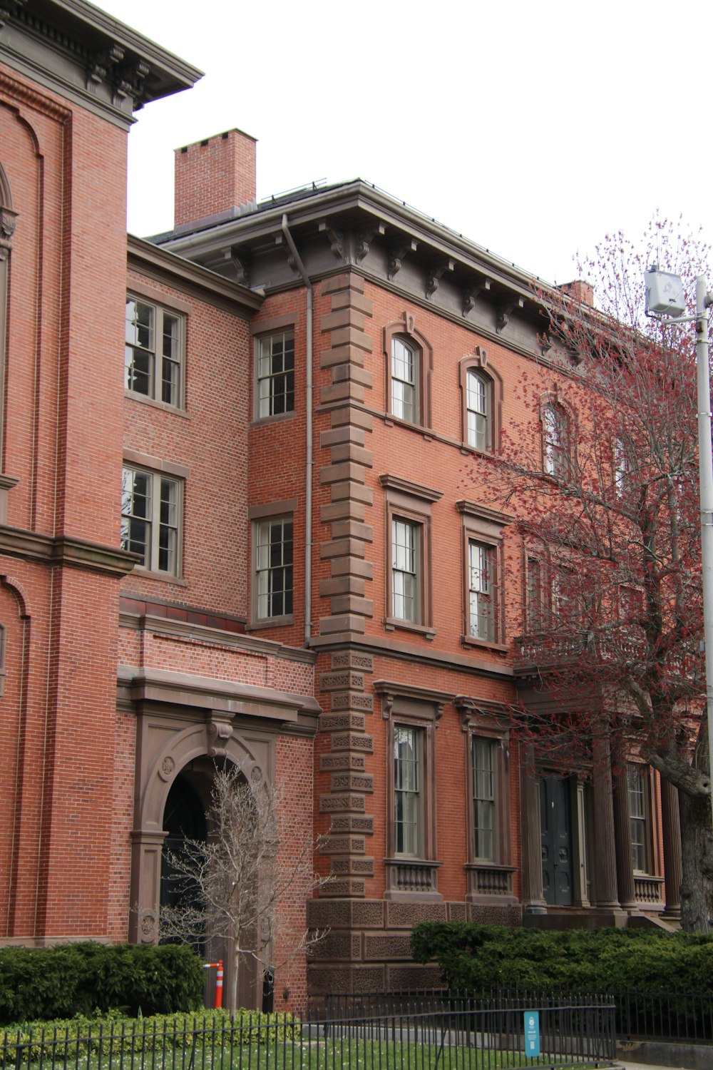 a large red brick building with a clock on the front of it