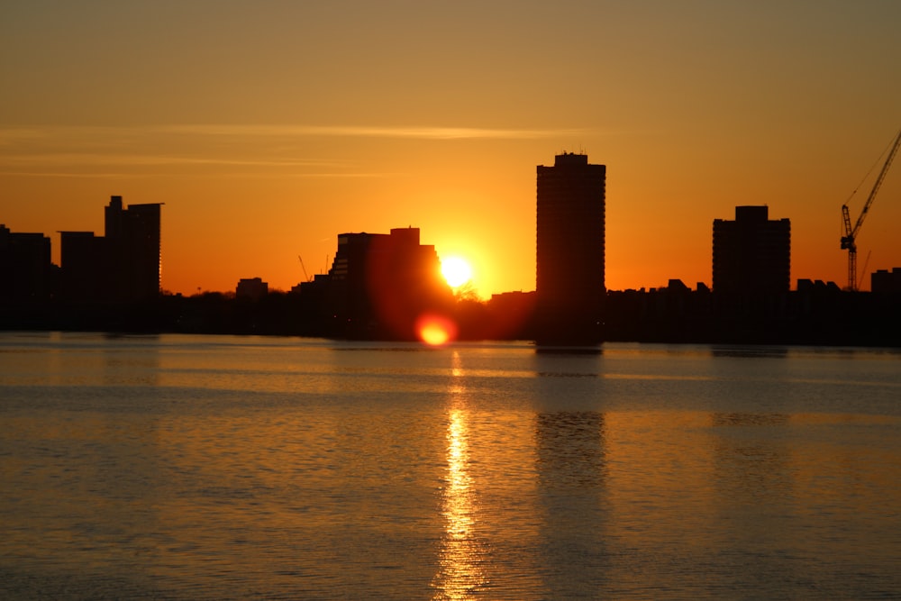 the sun is setting over the city skyline