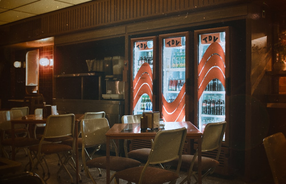 a restaurant with two vending machines and chairs