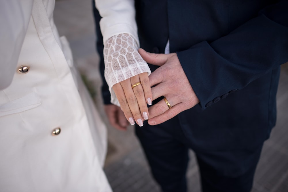 a close up of two people holding hands