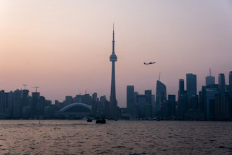 Illustration of a city skyline at dawn with soft pastel colors.