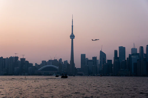 Illustration of a city skyline at dawn with soft pastel colors.