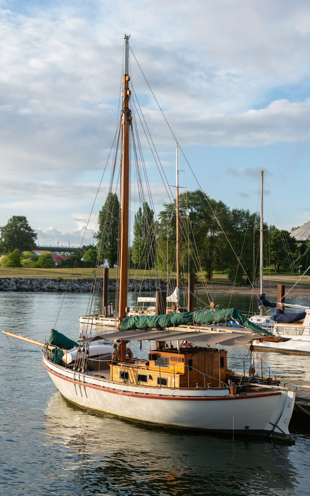 a sailboat in the water near a dock