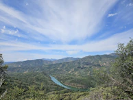 Panoramic view of the Madre de Dios river winding near forested land plots.
