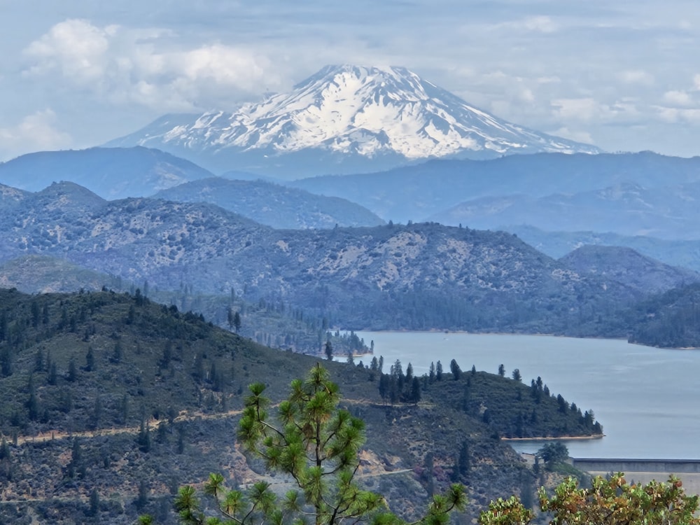 a view of a mountain range with a lake in the foreground