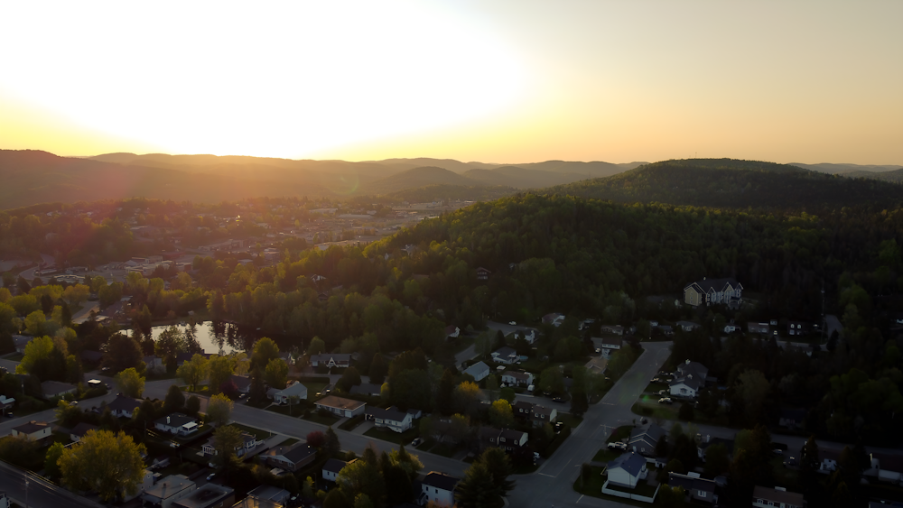 the sun is setting over a small town