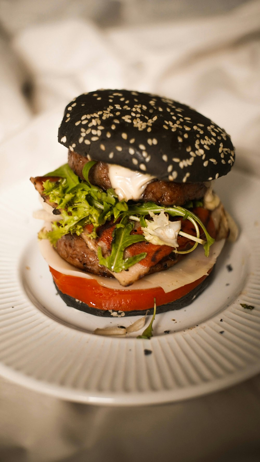 a hamburger with lettuce and tomato on a plate