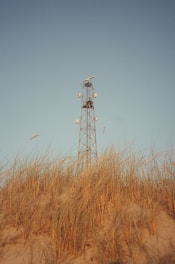 a tall tower sitting on top of a sandy beach