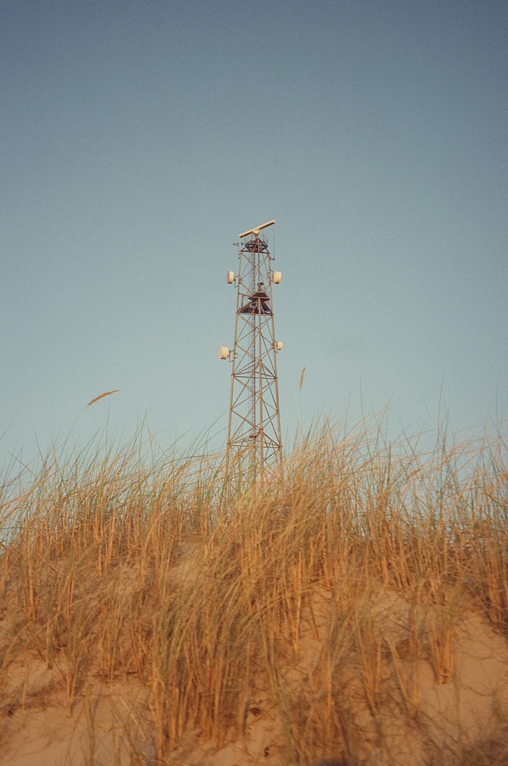 a tall tower sitting on top of a sandy beach