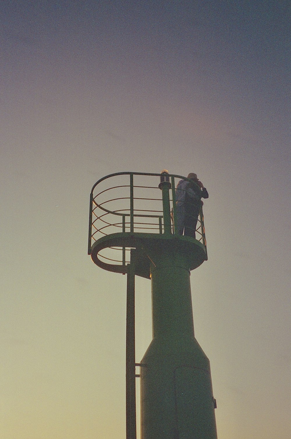 a man standing on top of a metal structure