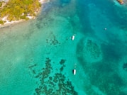 a group of boats floating on top of a body of water