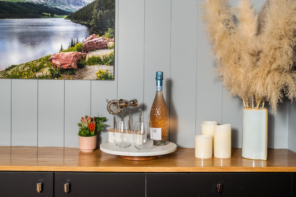 a wooden table topped with a bottle of wine