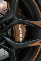 Detailed shot of a genuine Toyota brake disc resting on a sleek black surface.