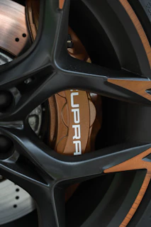 Detailed shot of a genuine Toyota brake disc resting on a sleek black surface.
