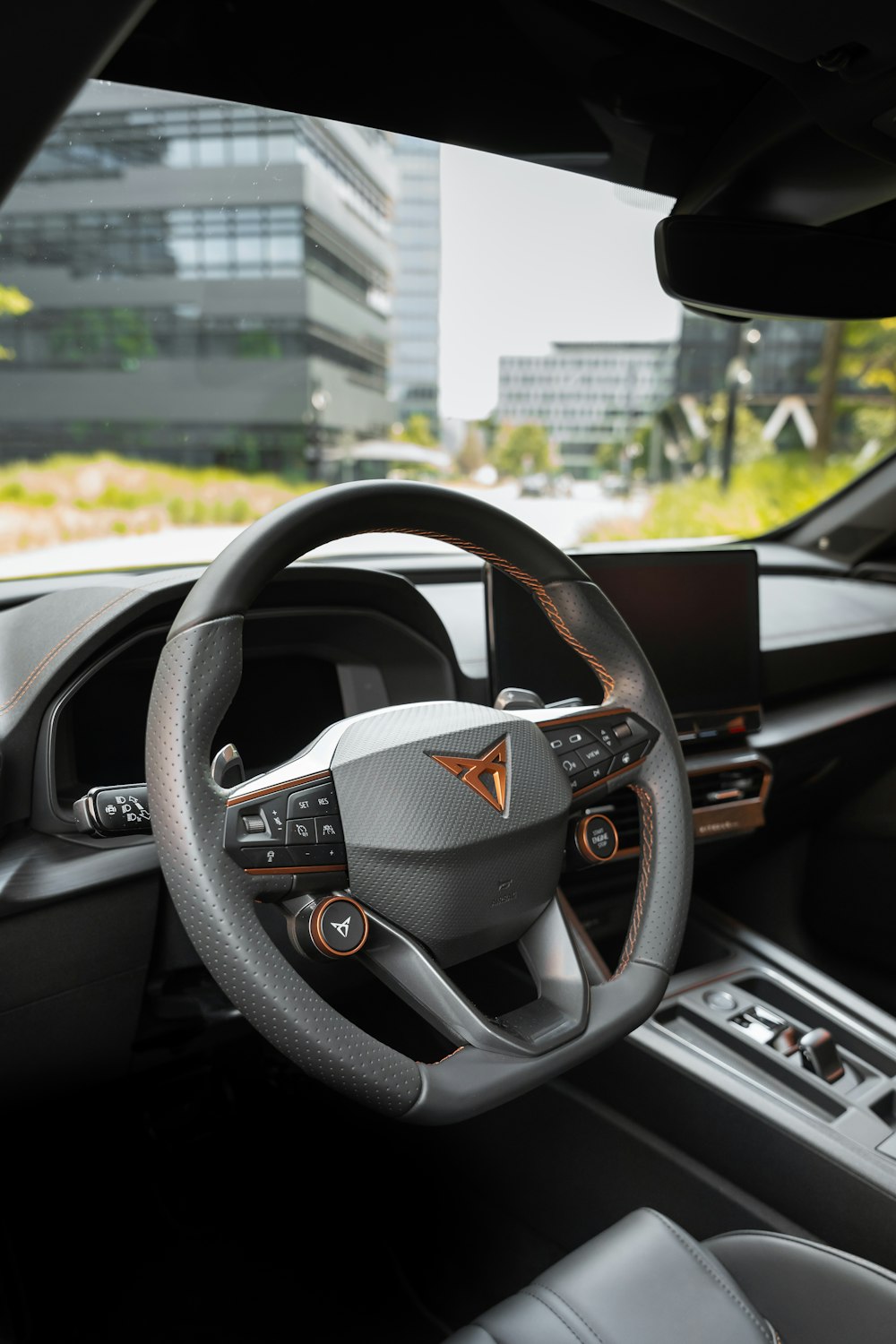 the interior of a car with a steering wheel and dashboard