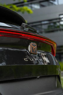 Rear view of a clean hatchback with Brazwrap plates driving down a Sabadell street