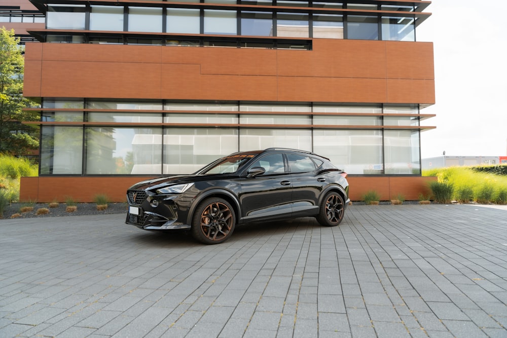 a black car parked in front of a building