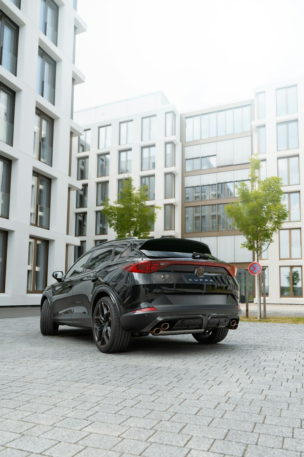 a black car parked in front of a building