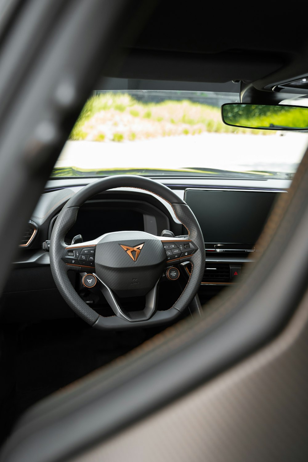 the interior of a car with a steering wheel and dashboard