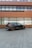 A sleek black SUV parked in front of a modern building.