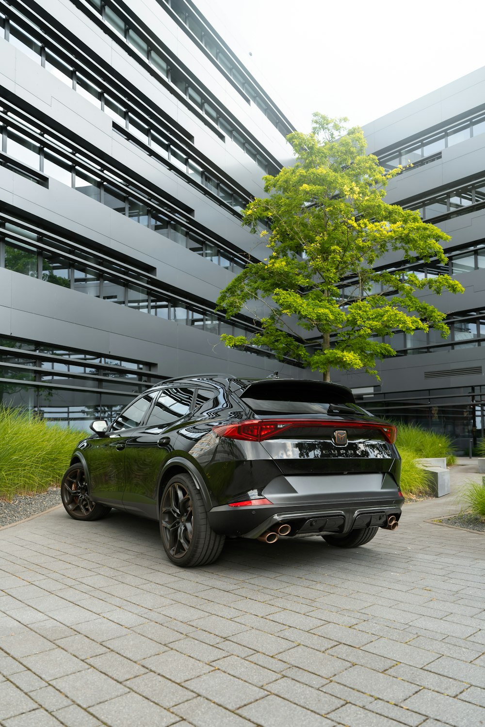 a black car parked in front of a building