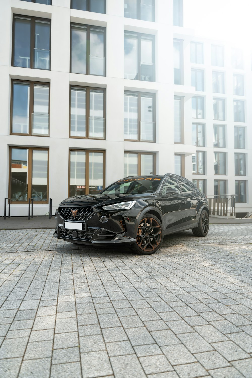 a black sports car parked in front of a building