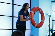 A presenter demonstrating emergency procedures with visual aids.