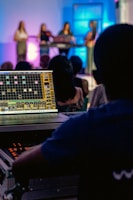 Close-up of sound and lighting technicians managing equipment during a live event
