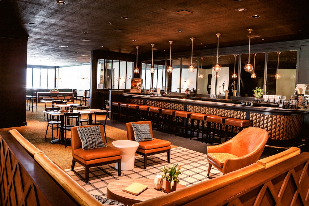 a bar with chairs and a bar counter