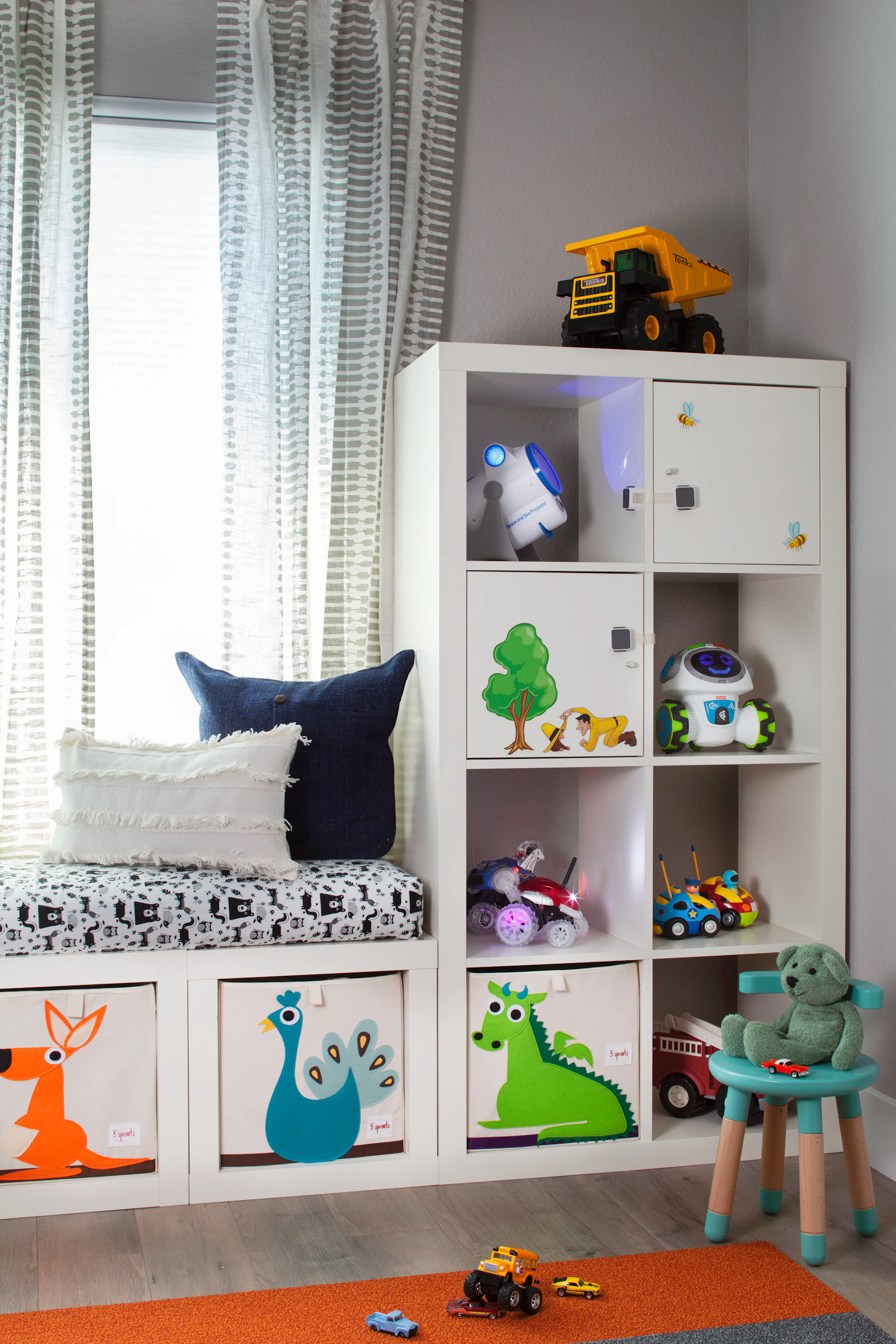 Bright children's playroom with toys and dinosaur-themed storage