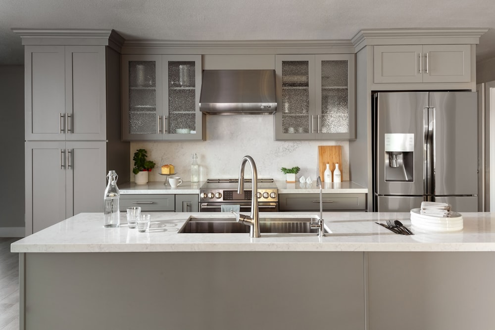 a kitchen with a sink, refrigerator, stove and dishwasher