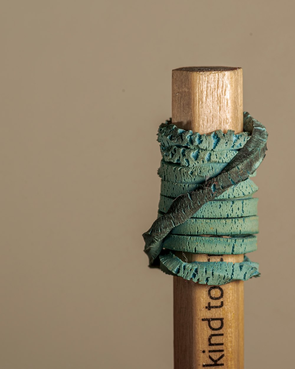 a close up of a wooden stick with a string wrapped around it